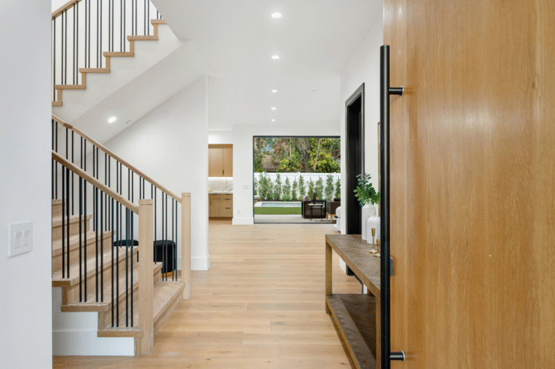 Modern entryway of a Melbourne home designed for year-round comfort, featuring timber accents, natural light, and energy-efficient materials - ideal for Ringwood’s seasonal climate.