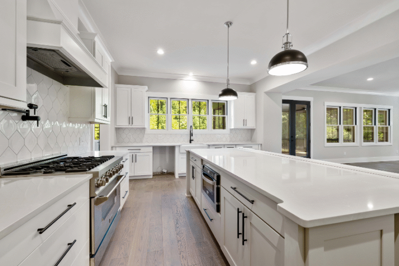 Contemporary Ringwood kitchen by a local builder featuring sleek stone benchtops, spacious island design, and modern pendant lighting.