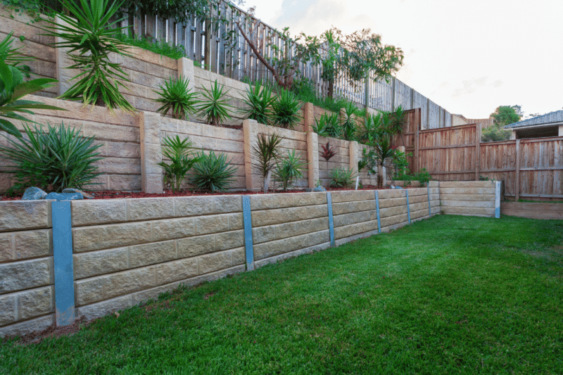 Tiered retaining walls on a sloped block in Melbourne, showcasing smart landscaping and structural support for custom home builds.